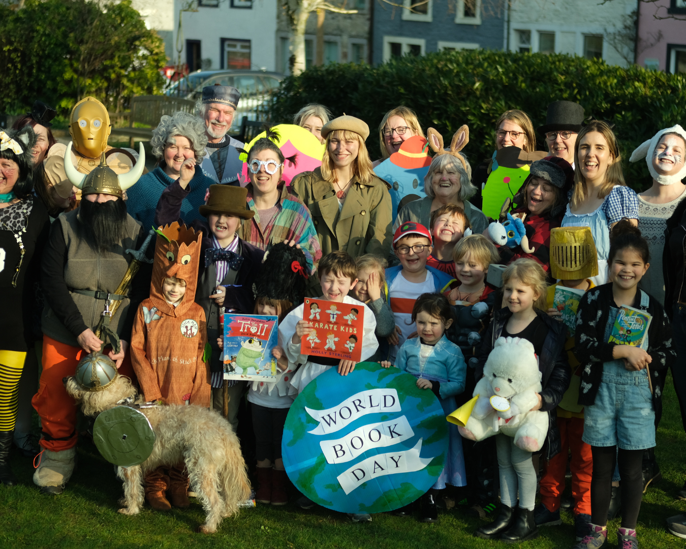 WFC staff, volunteers, Wigtown residents, booksellers and children dressed as their favourite book characters. Around 30 people stood in Wigtown Gardens, holding props, books and a large picture of the globe with the words 'World Book Day' printed on top.