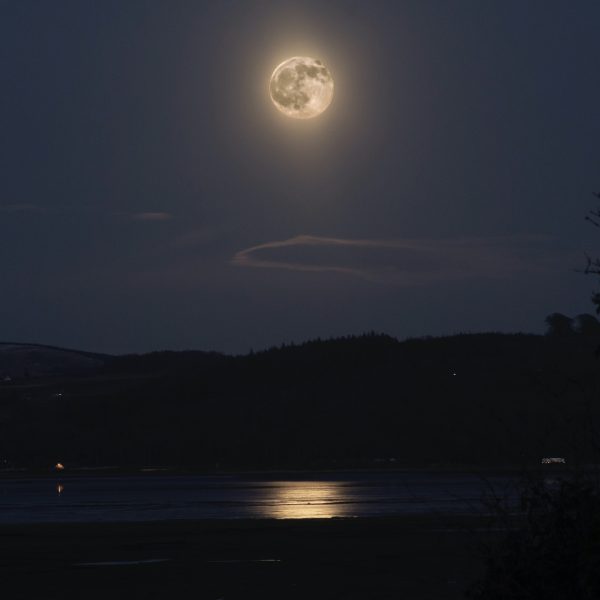 The Moon glow over Wigtown Bay. Reflections from the moon onto the still water.