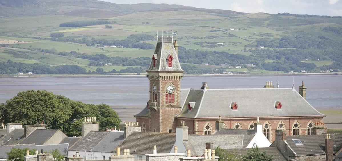 A view over house roof tops of the County Buildings, Wigtown, Scotland's National Book Town. Wigtown bay and the hills in the distance.