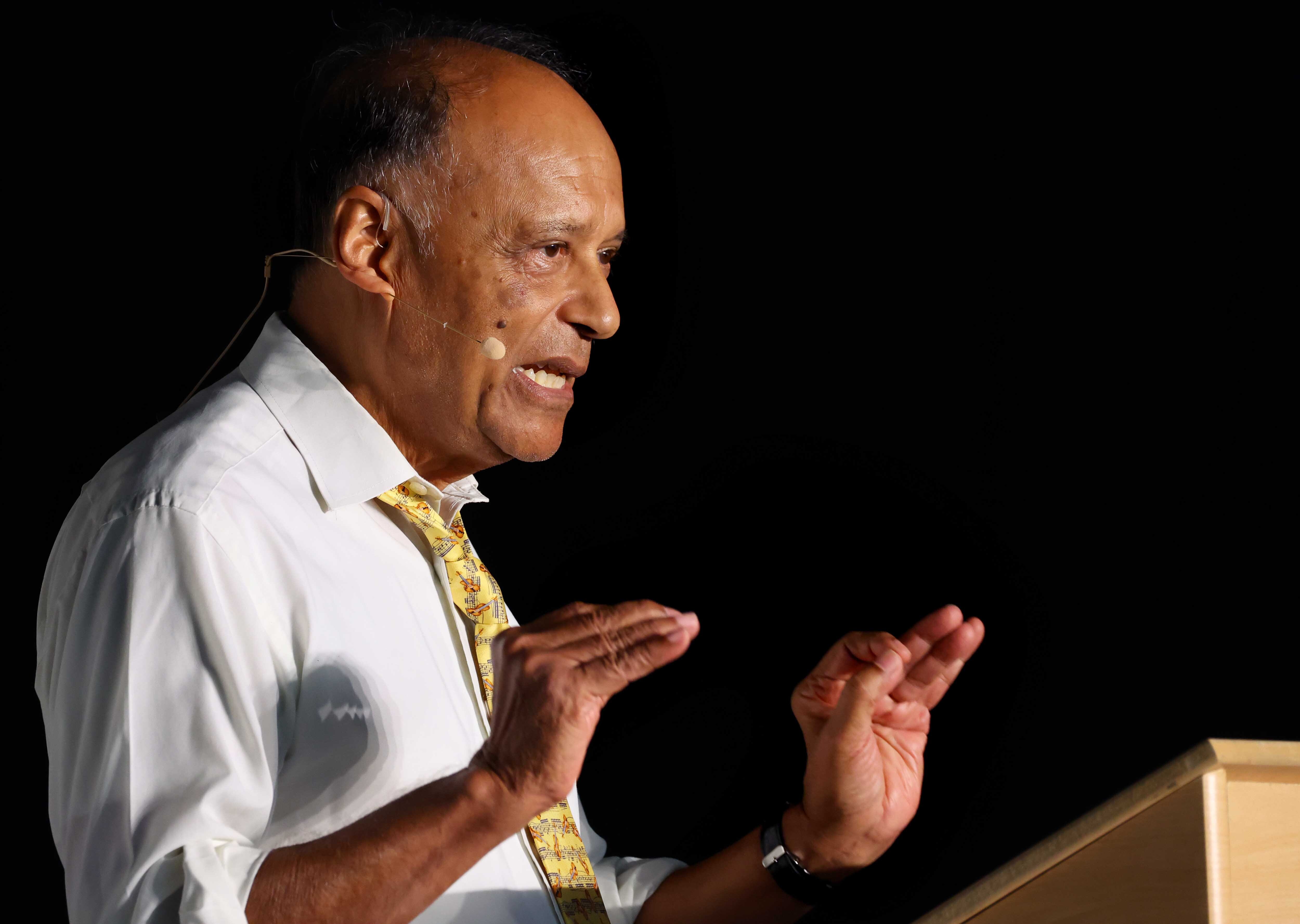 Professor Sir Partha Dasgupta speaks at a lectern.