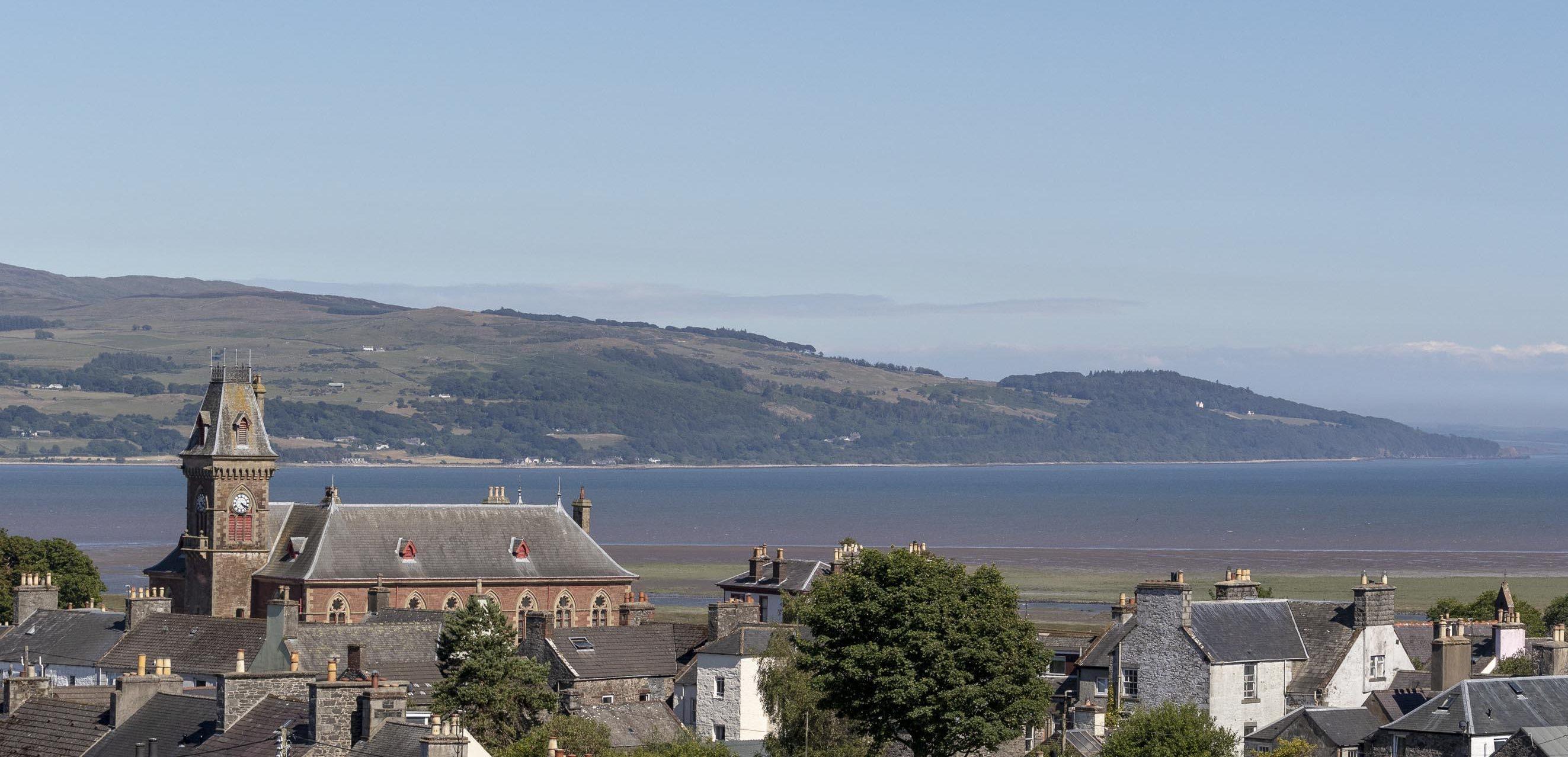 Rooftop view over Wigtown, the County Buildings clock tower, cree estuary and Galloway hills are in the distance.
