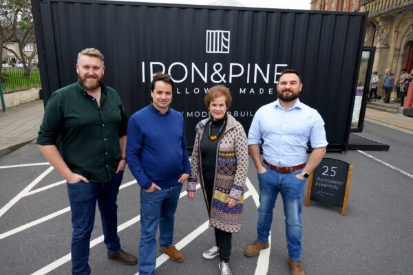 Two Iron and Pine executives, stood with Festival Director Adrian Turpin and Festival Chair Cathy Agnew, outside the Iron and Pine exhibition space, made from a shipping container.