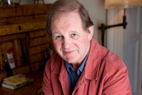 Wigtown Book Festival author Michael Morpurgo sitting at his desk.