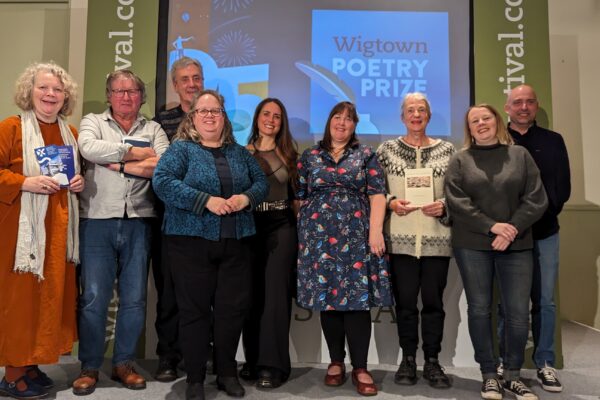 Winners, Judges and Sponsors of Wigtown Poetry Prizes 2023 stand on stage at the award ceremony.