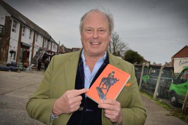 Portrait of James Braxton holding holding is new book 'Barty - a Tale of a Stolen Bronze'